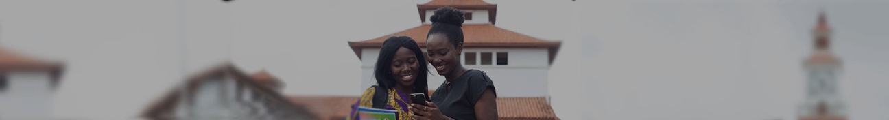 Two women looking at a mobile phone in Ghana